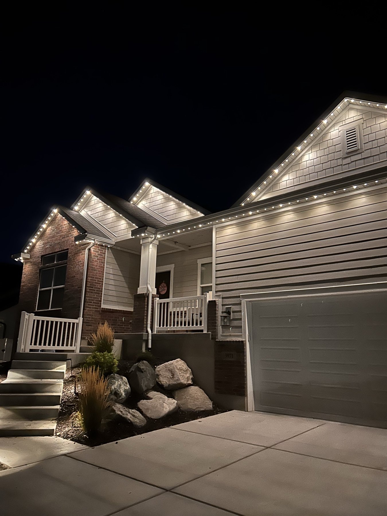White accent lights along the eaves beside a garage