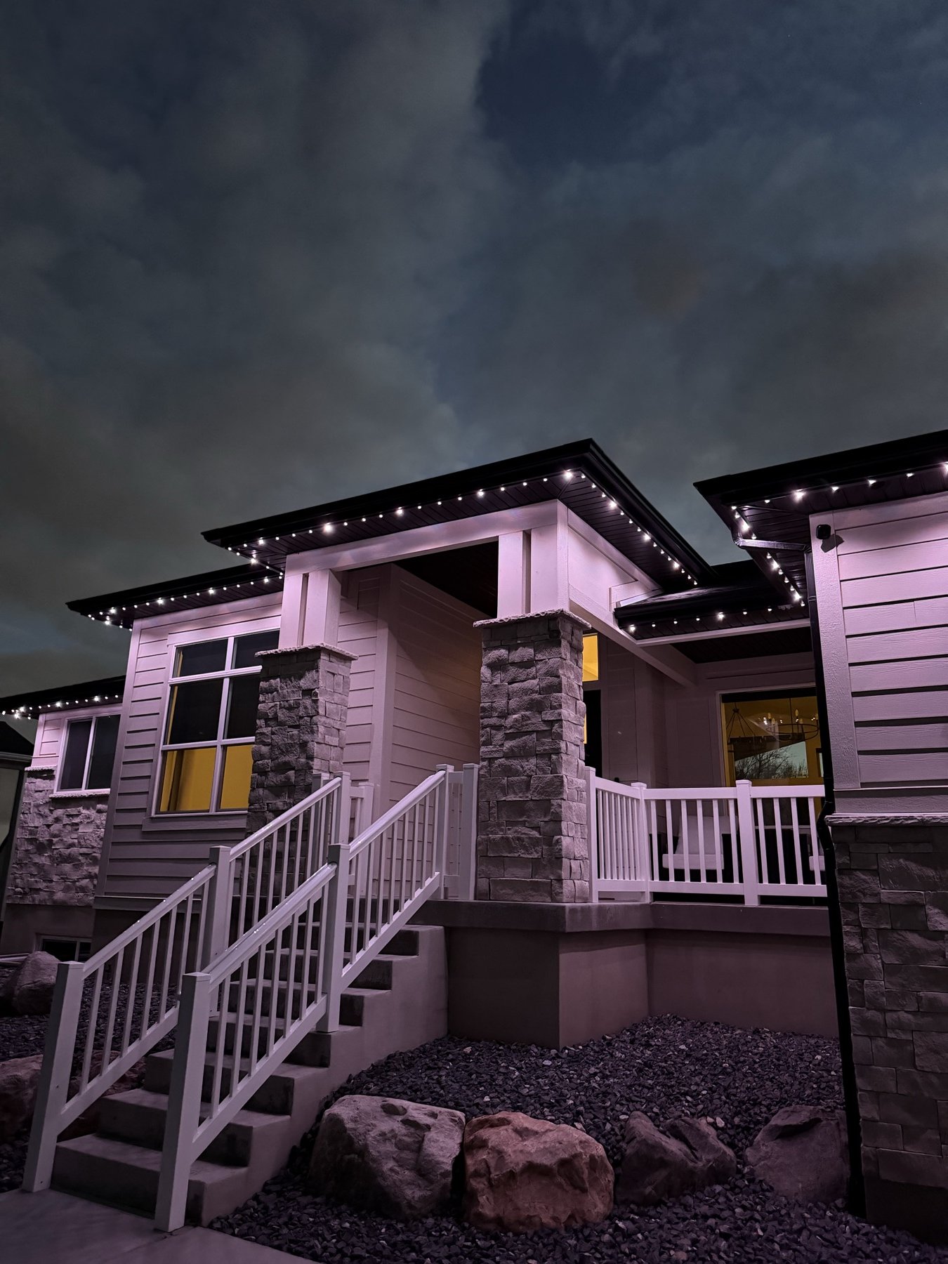Soft roofline lighting on a home with a front porch