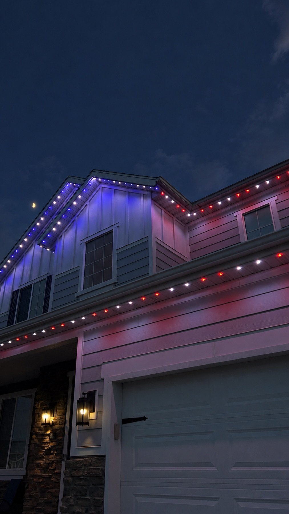 Red and blue holiday lights along a home’s roofline