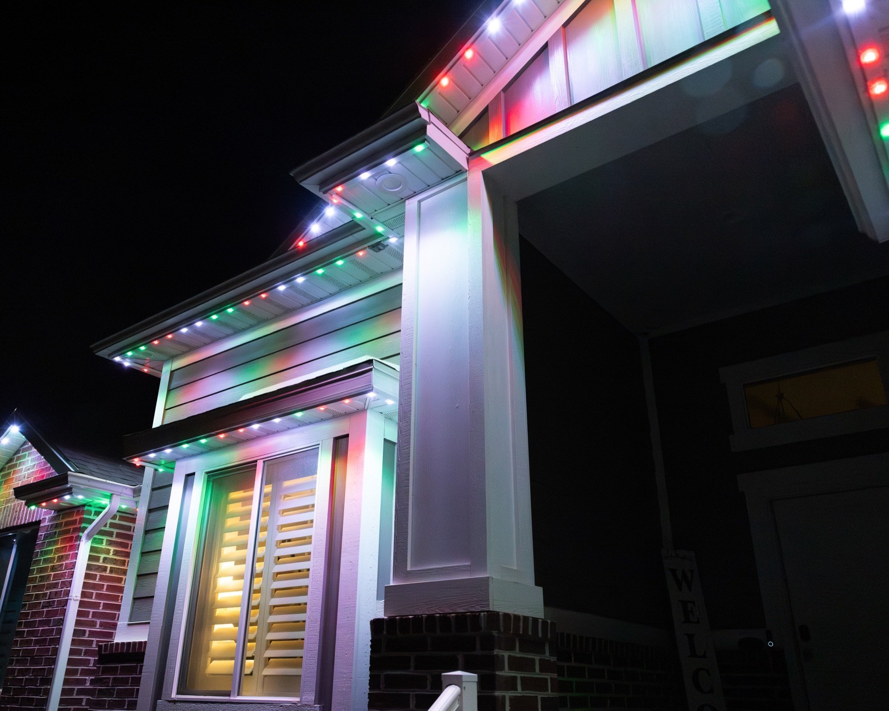Multicolor holiday lights above a porch
