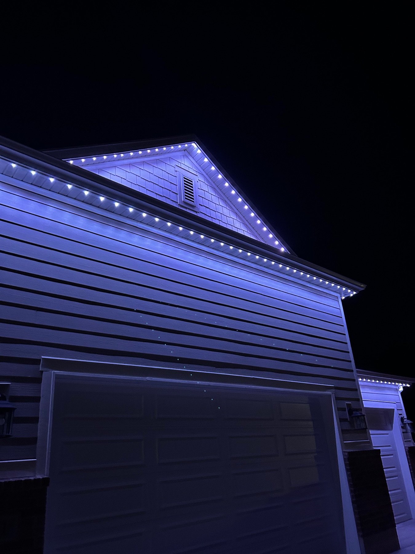 White lighting illuminating the side of a garage