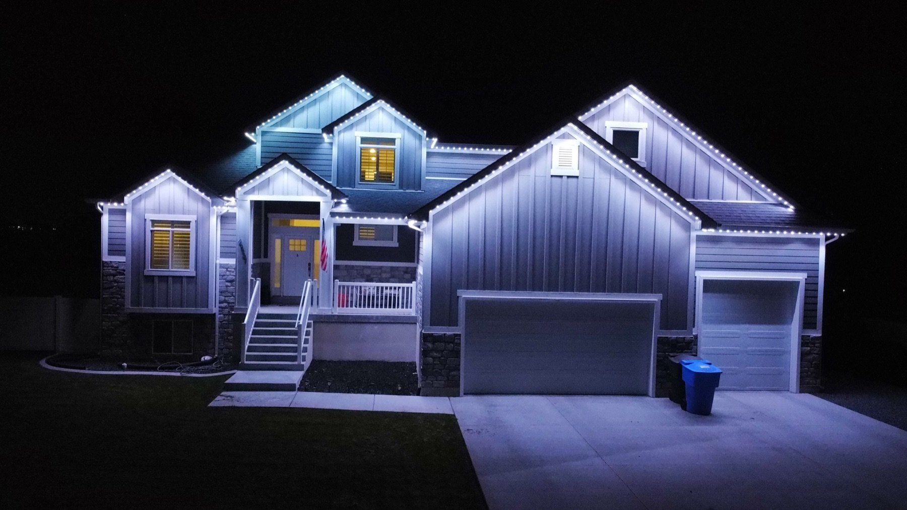 White lighting around a garage and front entrance